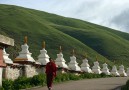 A young monk is walking alone at the monastery